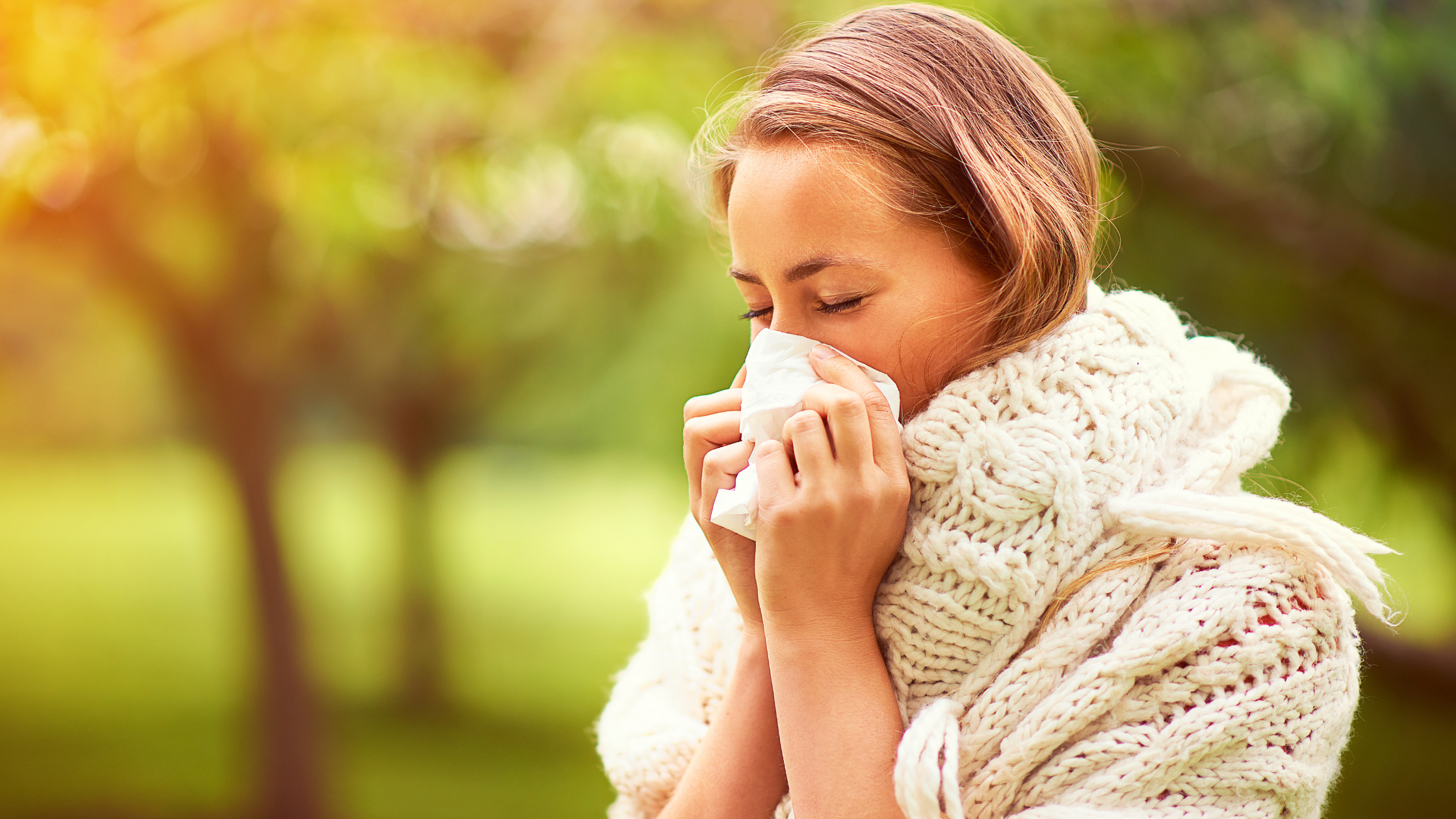 Woman sneezing - seasonal allergies and oral health